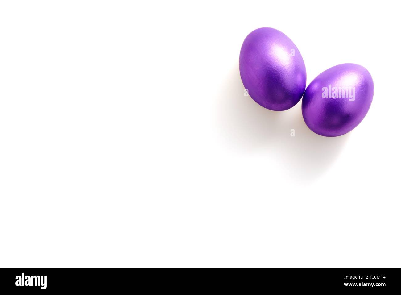 Purple easter eggs on white background with copy space for text. Colour ...