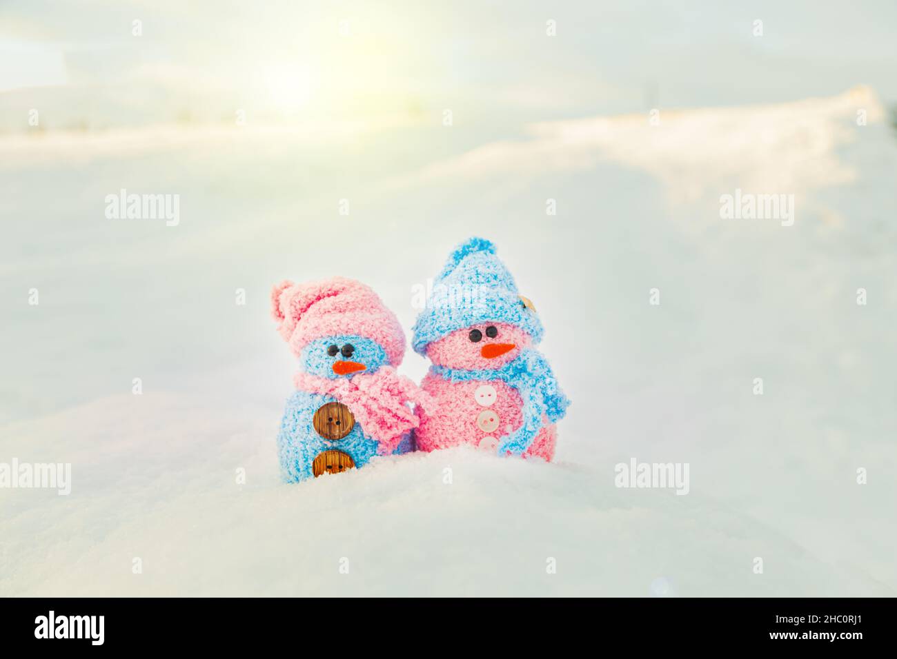 Cute homemade snowmen with scarves and hats. Winter's Tale. Greeting card with copy space. Winter background. Stock Photo