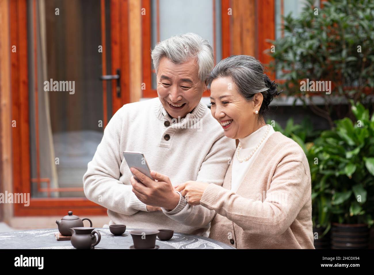 Old couple using a smartphone Stock Photo
