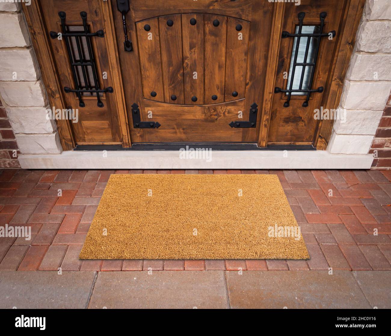 Blank Welcome Mat At Custom Front Door of House. Stock Photo