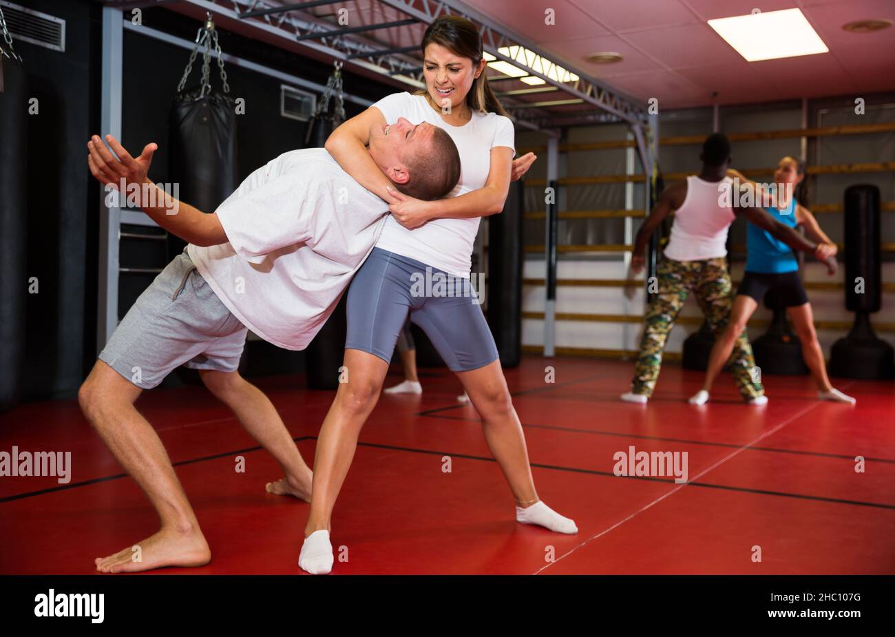 Woman makes choke hold in self-defense training Stock Photo - Alamy