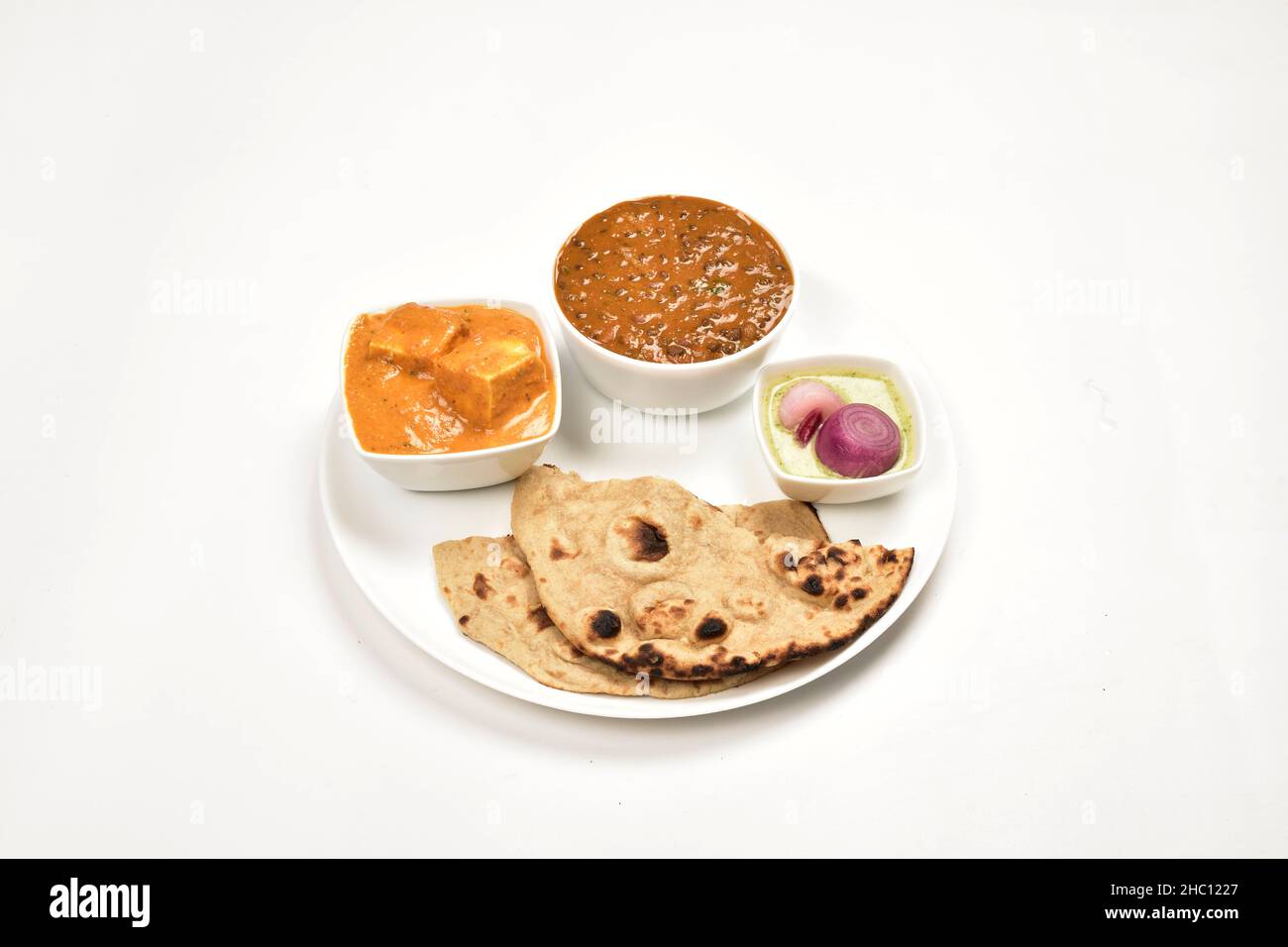 Dal Makhani and Shahi Paneer Served with Roti in Plate Isolated on White Background, Indian Main Course Stock Photo