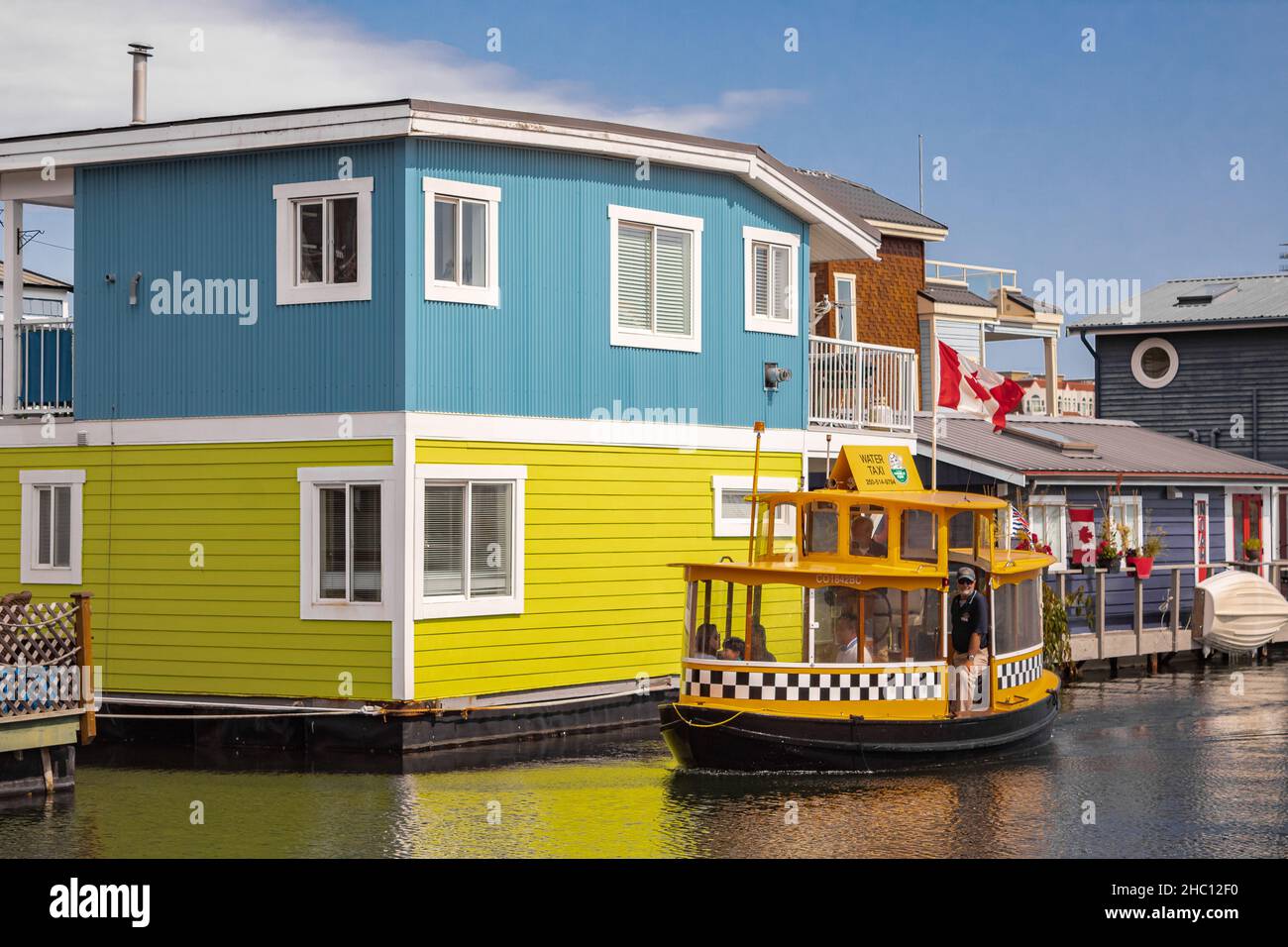 Floating Home Village Colorful Houseboats and water taxi. Fisherman's Wharf Reflection Inner Harbor, Victoria BC, Canada Pacific Northwest. Area has f Stock Photo