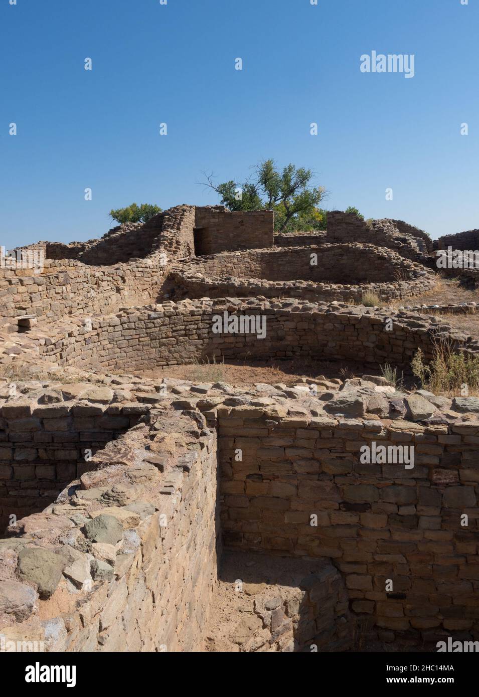 Remains of low stone walls from buildings and circular kivas at Aztec Ruins National Monument in Aztec, New Mexico. Stock Photo