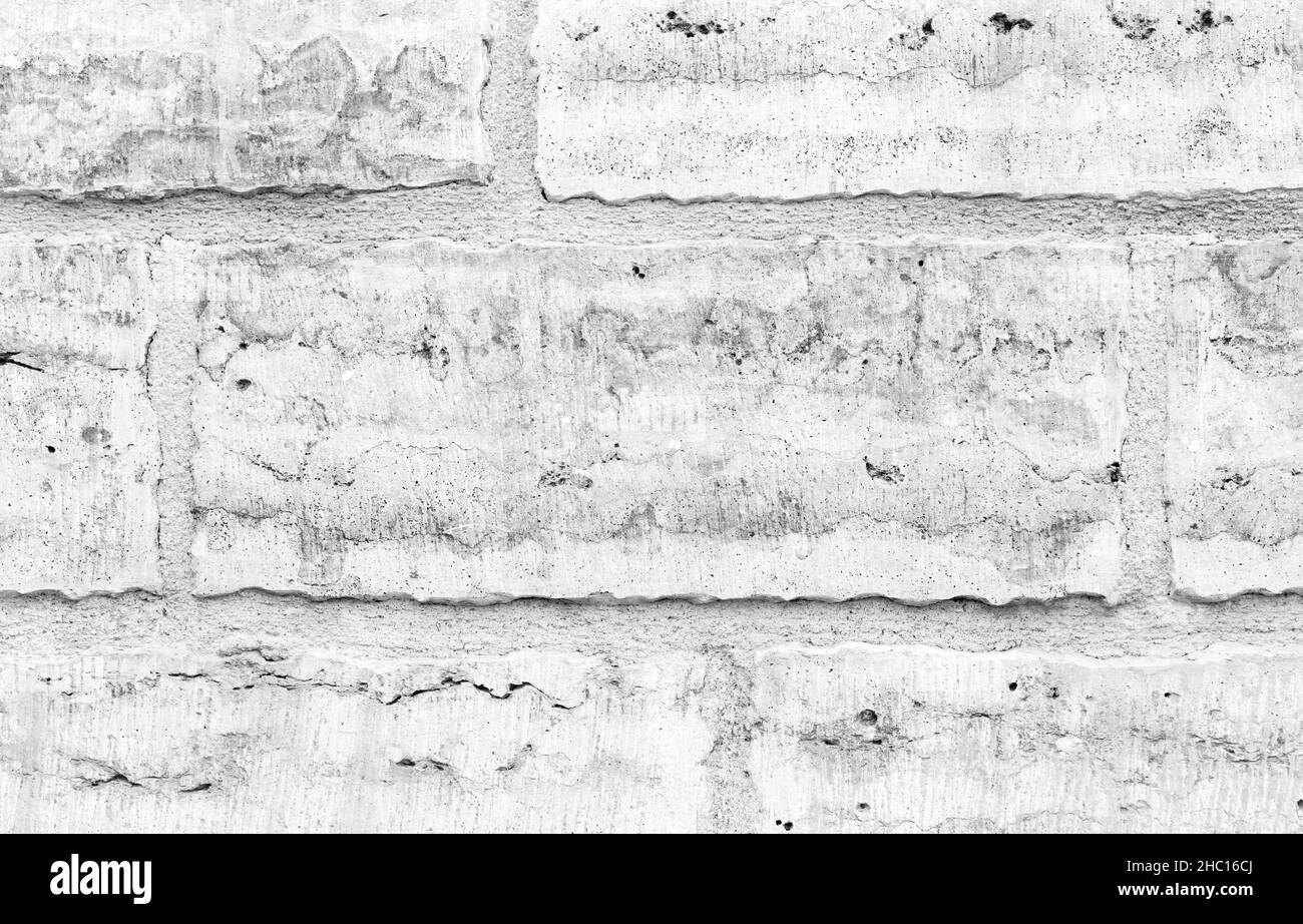 Grungy wall made of white rough stone blocks, flat background photo texture Stock Photo