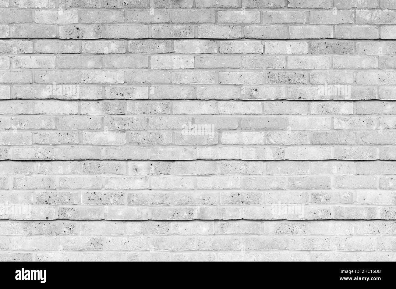 White brick wall with relief lines pattern, background photo texture