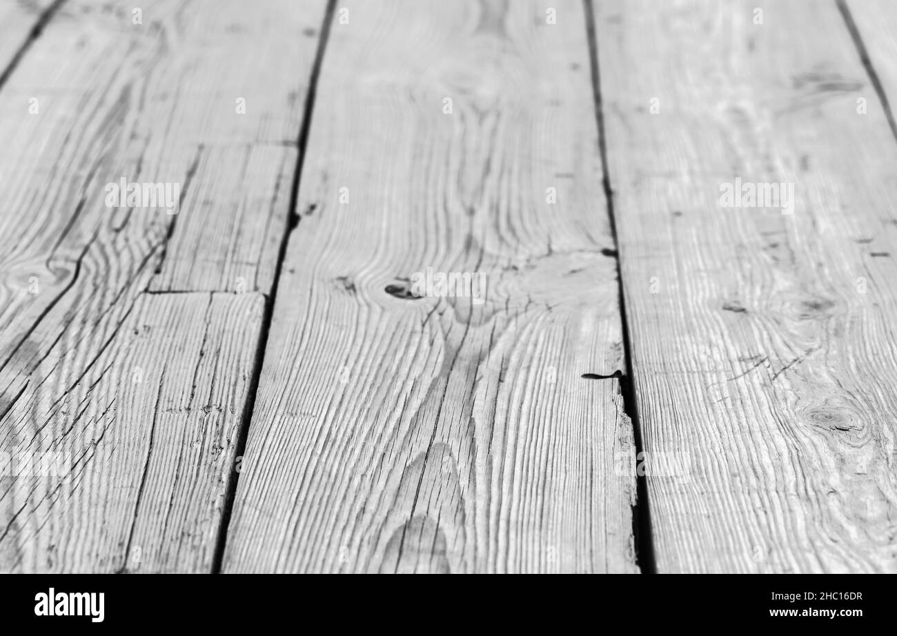 Vintage wooden floor made of rough bleached oak boards, background photo with selective focus and perspective effect Stock Photo