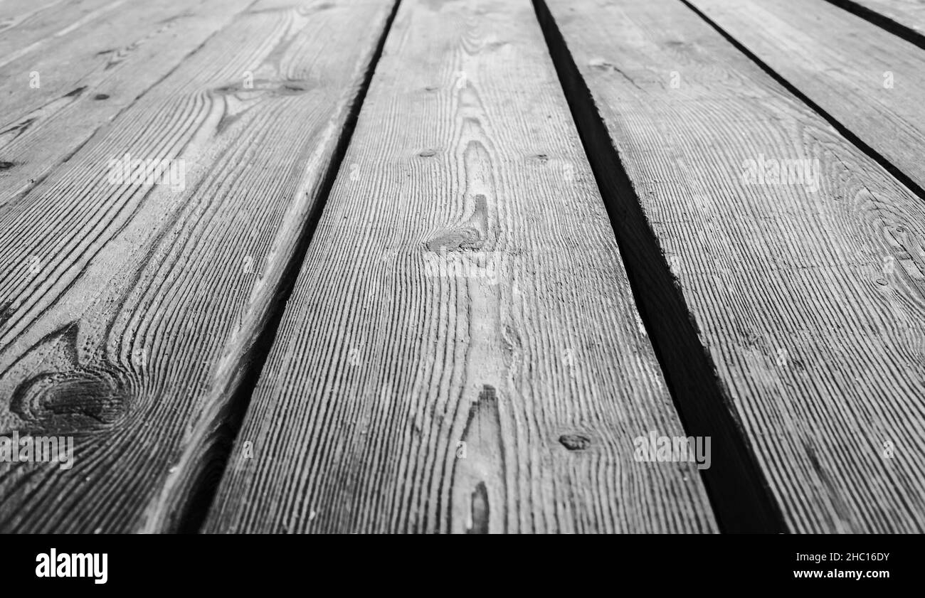 Vintage gray wooden floor made of rough oak boards, background photo with selective focus and perspective effect Stock Photo