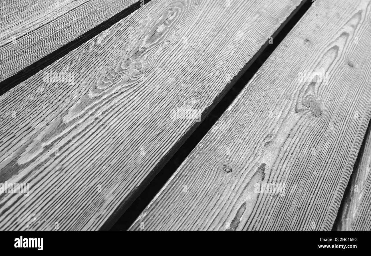 Vintage wooden floor made of rough gray oak boards, background photo with selective focus Stock Photo
