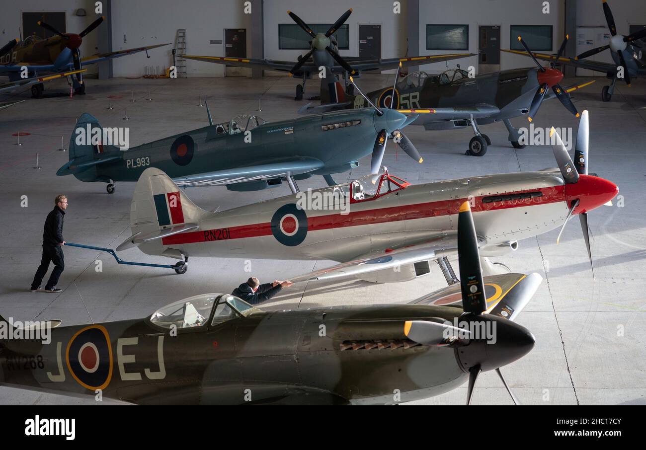 Twelve Spitfires are assembled during a photo call for IWM Duxford's Spitfire: Evolution of an Icon exhibition. The largest collection of Supermarine Spitfires under one roof assembled for the first time, from some of the first Spitfires to see combat, to a pre-restoration aircraft that has been brought out of storage for the first time since 2013. Picture date: Wednesday December 22, 2021. Stock Photo