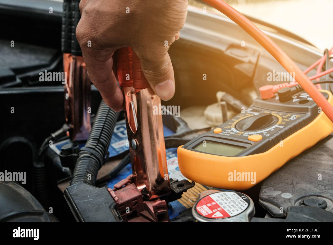 Mechanic hand use multimeter voltmeter to check the voltage level in a