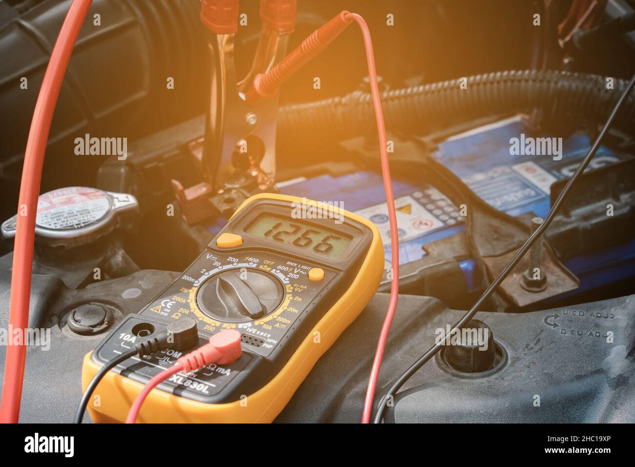 Mechanic hand use multimeter voltmeter to check the voltage level in a