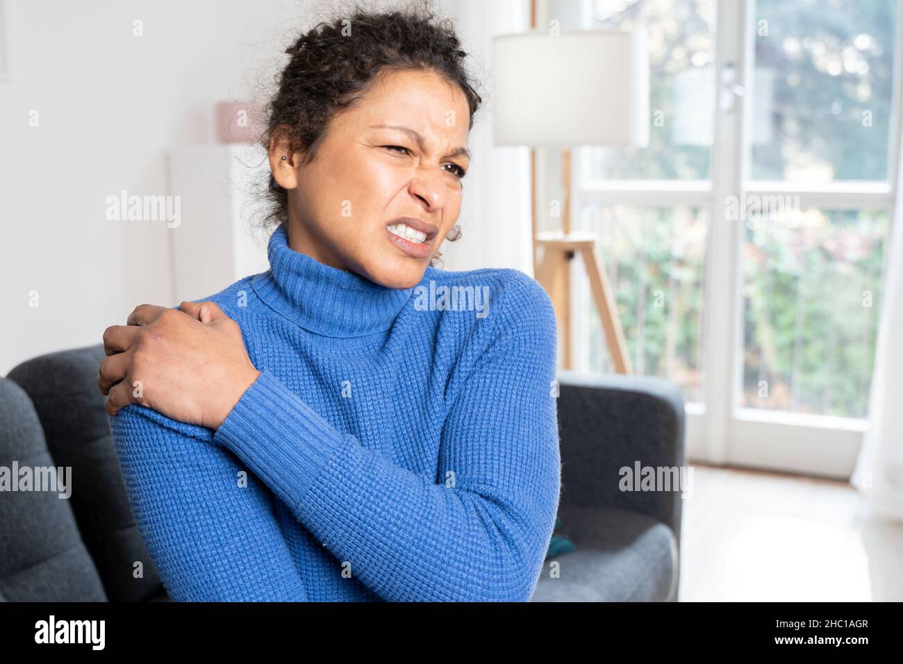 Black woman suffering back pain because of bad posture Stock Photo