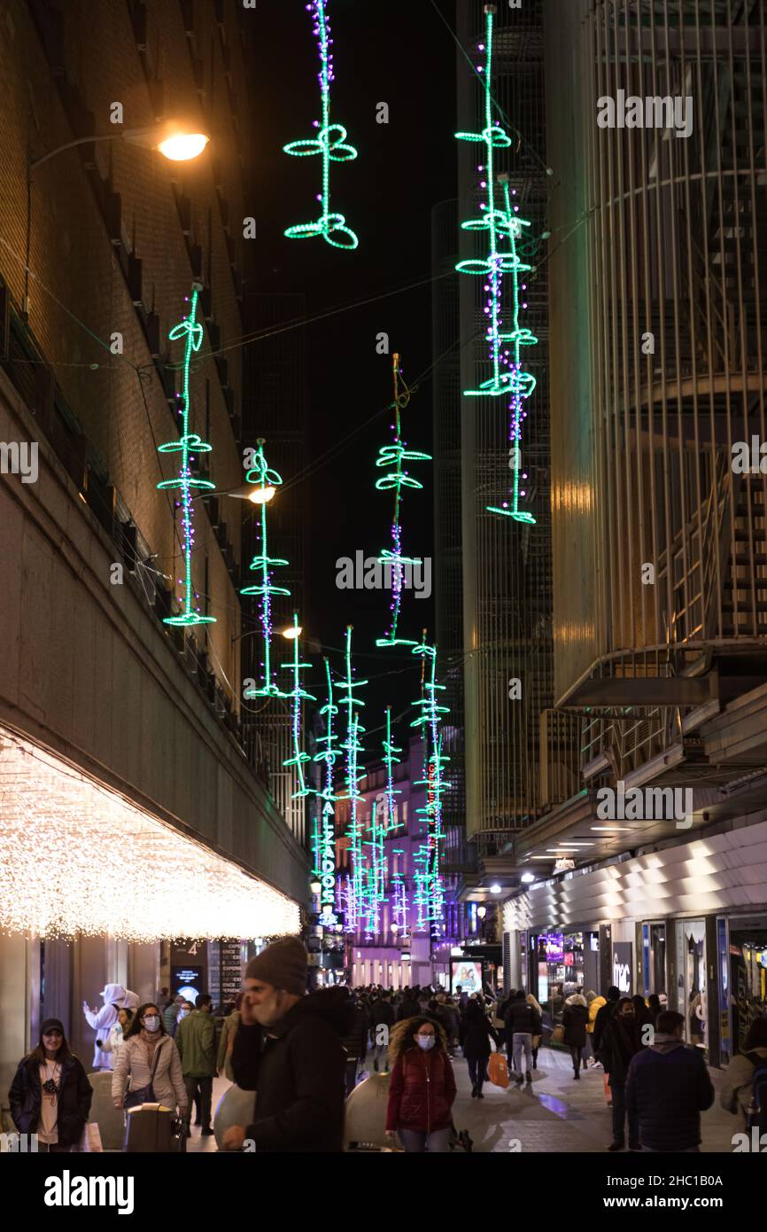 Madrid, Spain - December 13, 2021: Christmas lights shine on El Carmen street n Madrid, Spain. Stock Photo