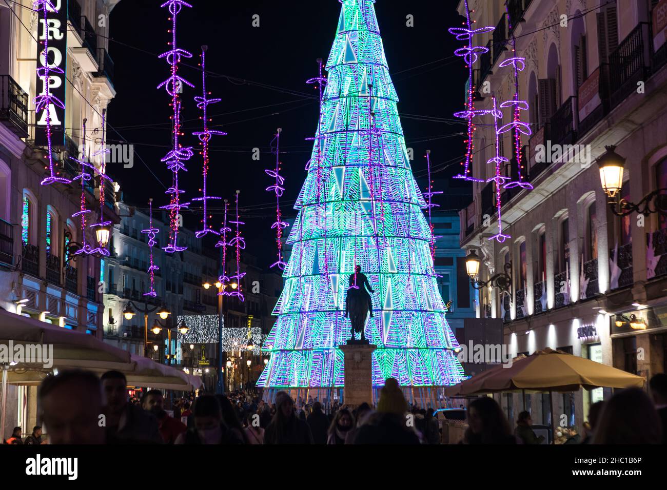 Madrid, Spain - December 13, 2021: Christmas lights shine on El Carmen street n Madrid, Spain. Stock Photo