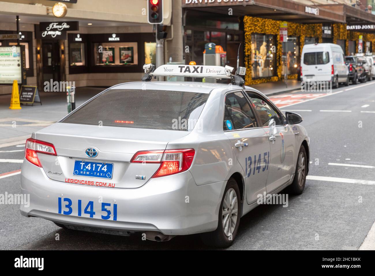Toyota taxi in Sydney city centre looking for fares in December 2021 as streets remain quiet due to covid omicron,Sydney,Australia Stock Photo