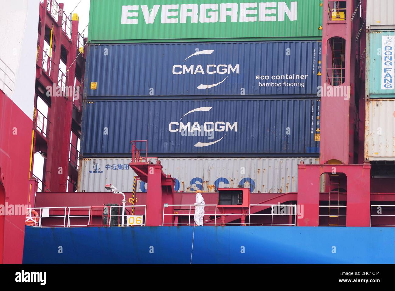QINGDAO, CHINA - DECEMBER 23, 2021 - A crew member walks on board the China Ocean Global Ship at the Foreign trade container terminal at Qingdao Port Stock Photo