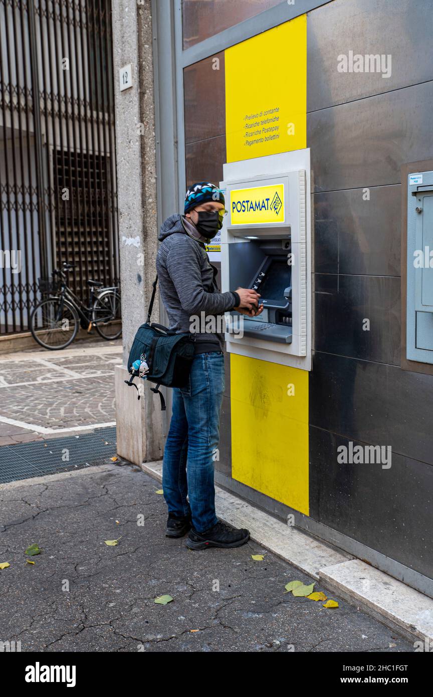 terni,italy december 23 2021:man at the post office cash machine picking up Stock Photo