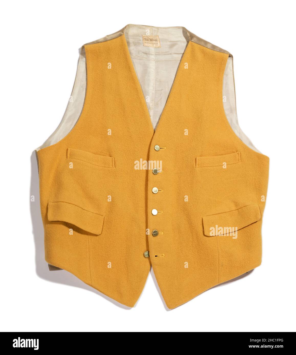 A yellow wool fabric waistcoat with gold coloured metal buttons Stock