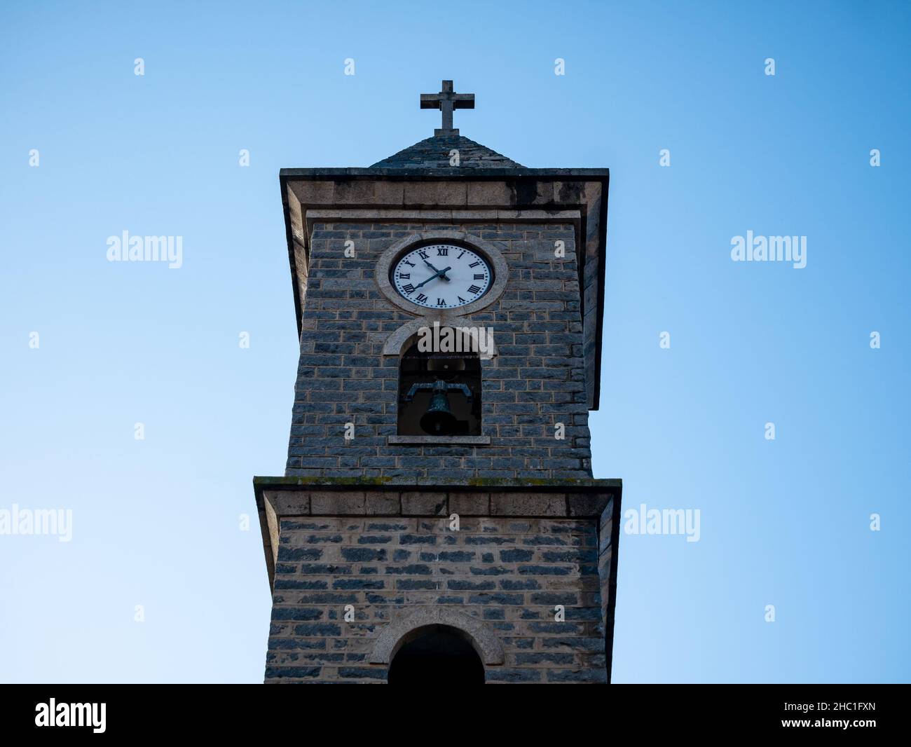 front view of the facade of a tower with bell tower and clock Stock Photo