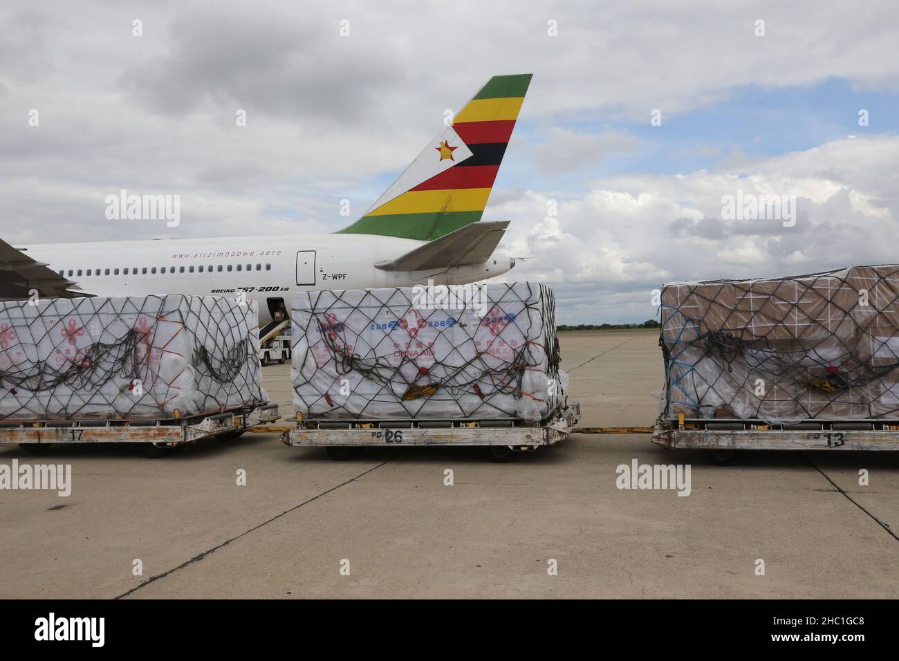 Harare, Zimbabwe. 20th Dec, 2021. A batch of COVID-19 vaccine donated by China arrives at Robert Gabriel Mugabe International Airport in Harare, Zimbabwe, on Dec. 20, 2021. Zimbabwe on Monday received a batch of Sinovac COVID-19 vaccine donated by China, which will boost the country's vaccination campaign as it battles the fourth wave of COVID-19 pandemic. Credit: Zhang Yuliang/Xinhua/Alamy Live News Stock Photo