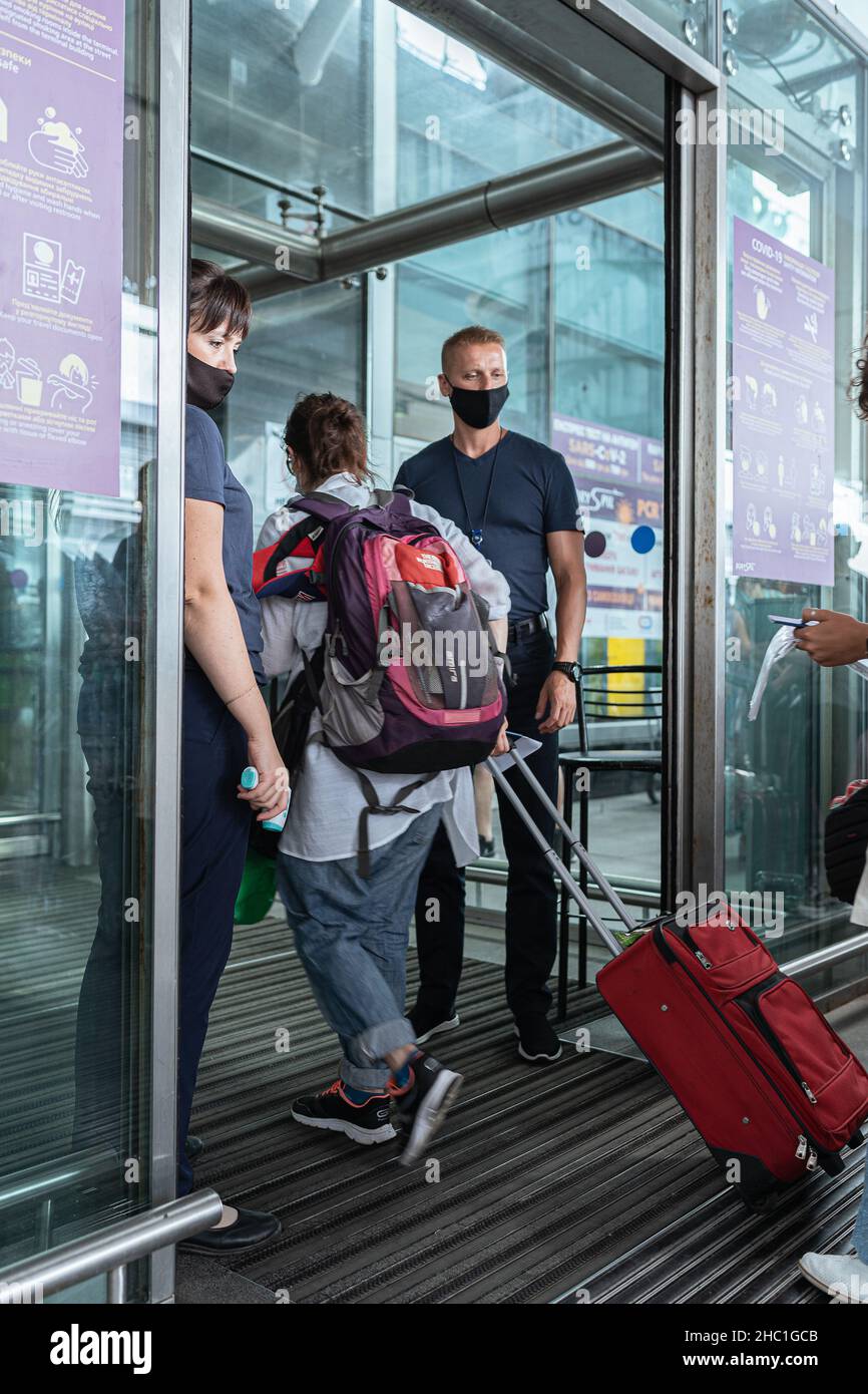 Monitoring health of passengers and COVID-certificate about vaccination with a QR code at entrance to international airport. Boryspil Airp Stock Photo