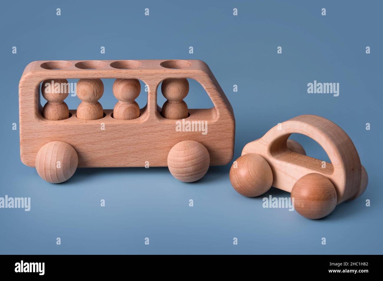 Wooden cars, baby toy for child on blue background. Eco friendly