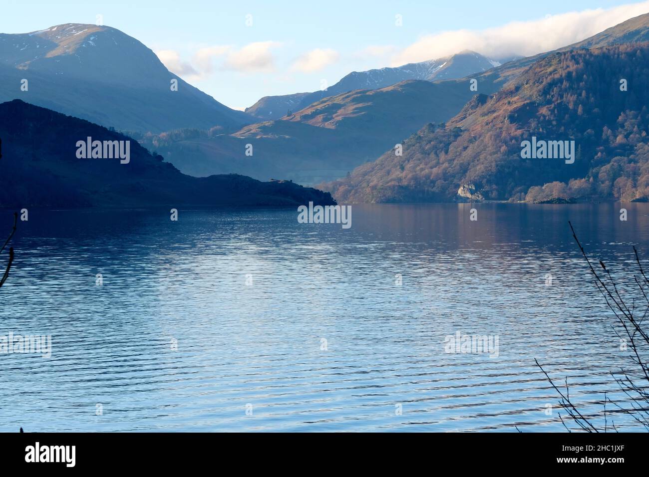 Lakeside Views of Ullswater in Cumbria the Lake District Nation Park. Morning light, fell views with a slight mist. Blue reflections. Stock Photo