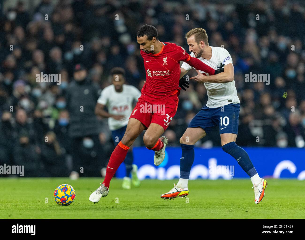 (211220) -- LONDON, Dec. 20, 2021 (Xinhua) -- Liverpool's Joel Matip (L) is challenged by Tottenham Hotspur's Harry Kane during the English Premier League match between Tottenham Hotspur and Liverpool in London, Britain, on Dec. 19, 2021. (Xinhua)FOR EDITORIAL USE ONLY. NOT FOR SALE FOR MARKETING OR ADVERTISING CAMPAIGNS. NO USE WITH UNAUTHORIZED AUDIO, VIDEO, DATA, FIXTURE LISTS, CLUB/LEAGUE LOGOS OR 'LIVE' SERVICES. ONLINE IN-MATCH USE LIMITED TO 45 IMAGES, NO VIDEO EMULATION. NO USE IN BETTING, GAMES OR SINGLE CLUB/LEAGUE/PLAYER PUBLICATIONS. Stock Photo