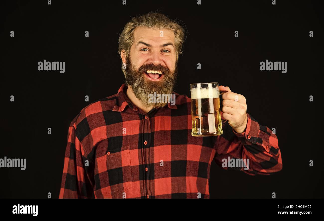 Controlling beer quality. Brutal bearded male drinks beer from glass. Beer pub. bartender or barman in bar. recreation. Man hold glass of beer Stock Photo