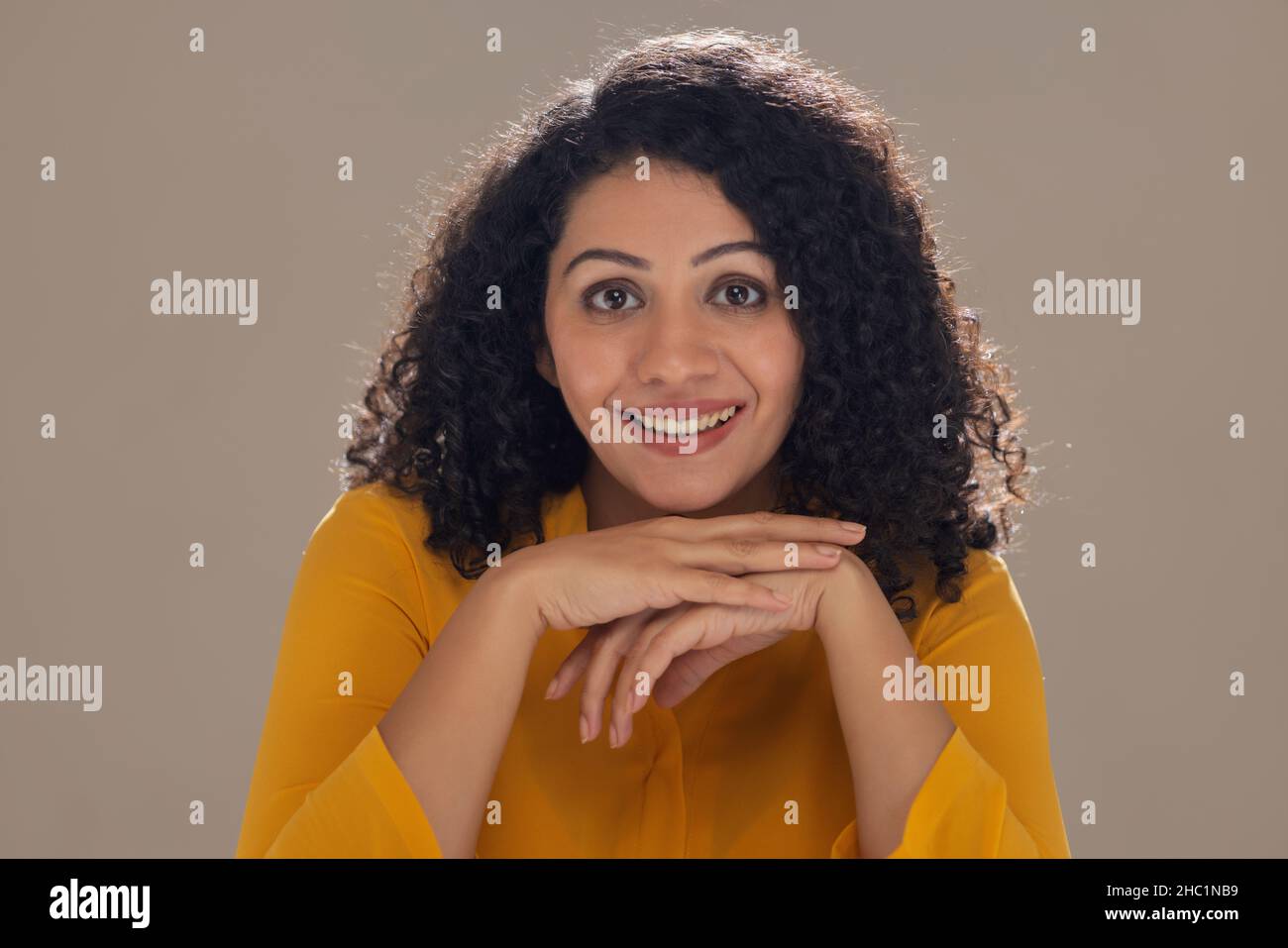 Beautiful young woman looking at camera with smile Stock Photo - Alamy