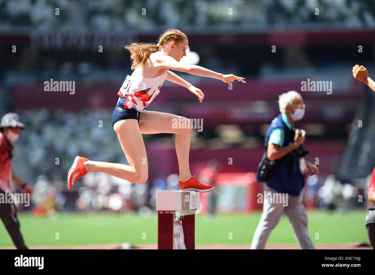 Female runners jumping the obstacle in the estuary in the 3000 meter ...