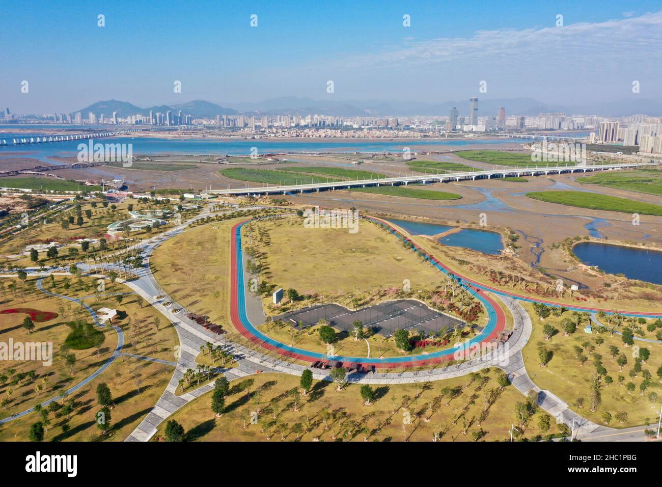 (211221) -- XIAMEN, Dec. 21, 2021 (Xinhua) -- Aerial photo taken on Dec. 8, 2021 shows the view of a park and a wetland in Xiang'an District of Xiamen, southeast China's Fujian Province. This year marks the 40th anniversary of the establishment of the Xiamen Special Economic Zone (SEZ). The Xiamen SEZ has made important contributions to the country's reform, opening up, and socialist modernization, and played a unique role in promoting national reunification. (Xinhua/Jiang Kehong) Stock Photo