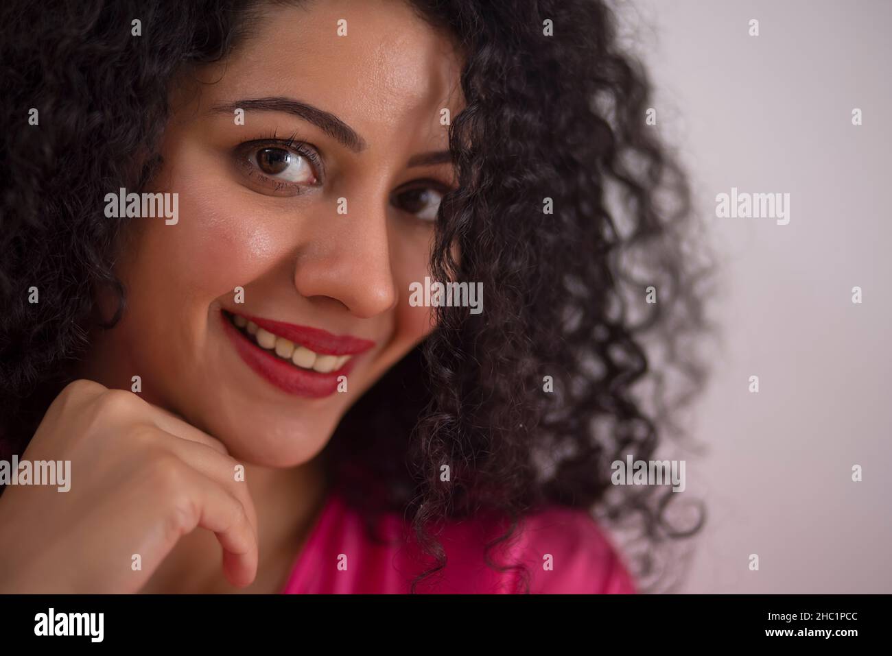 Close-up portrait of a beautiful smiling young woman Stock Photo
