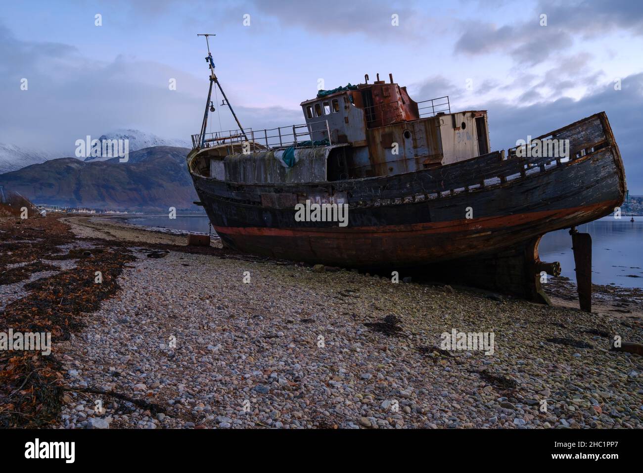 The Corpach Shipwreck, also known as the Old boat of Caol at Loch Eil near Fort William, Scotland, with the snow covered BenNevis in the background. Stock Photo