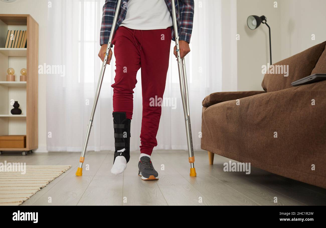 Man with broken leg at home tries to walk with crutches and succeeds in
