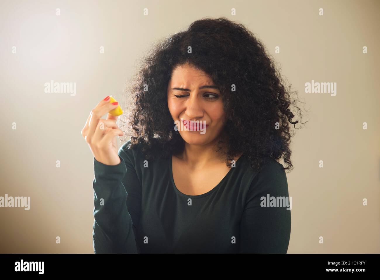 Woman's expression after eating sour lemon Stock Photo Alamy