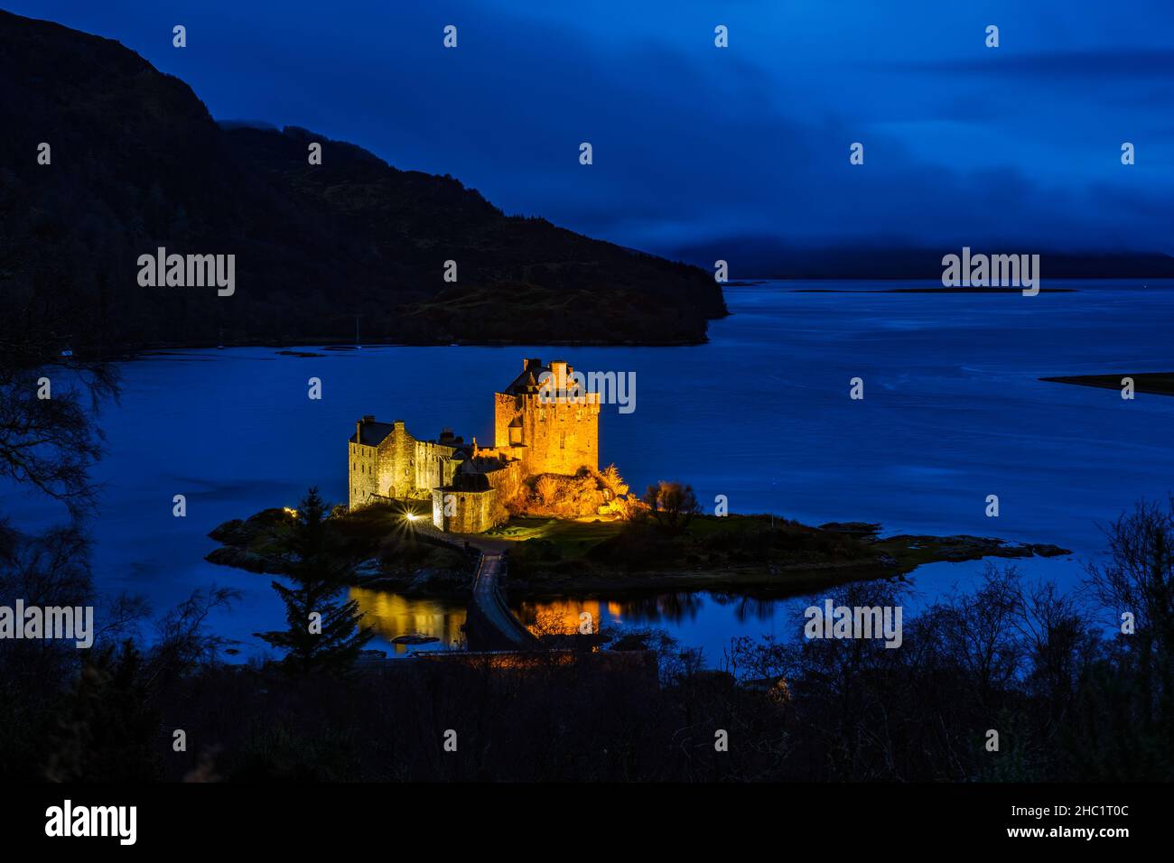 Eileen Donan Castle in the western Scottish Highlands, floodlit at night. Stock Photo