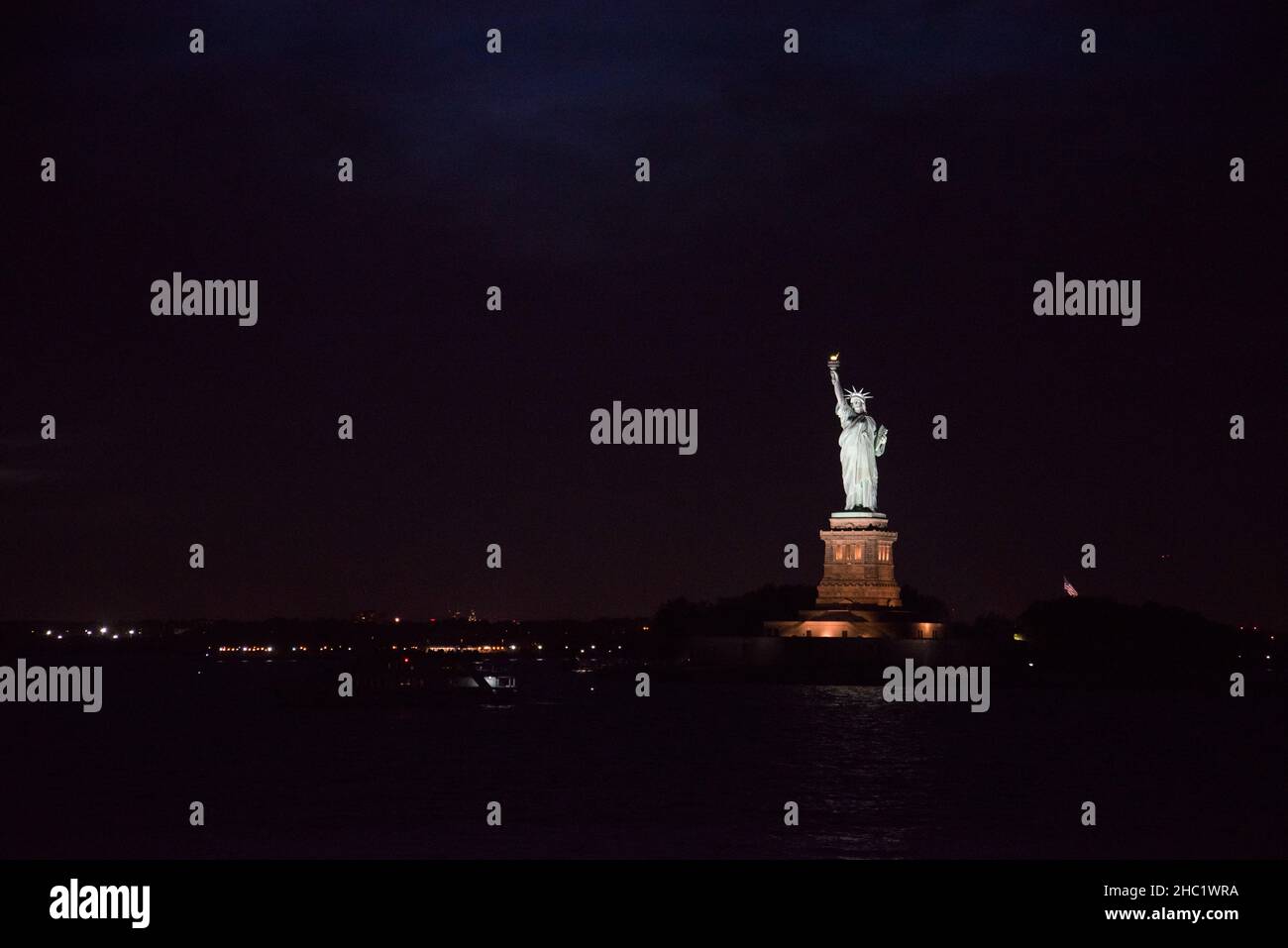 Iconic Statue of Liberty in New York City at night, USA Stock Photo