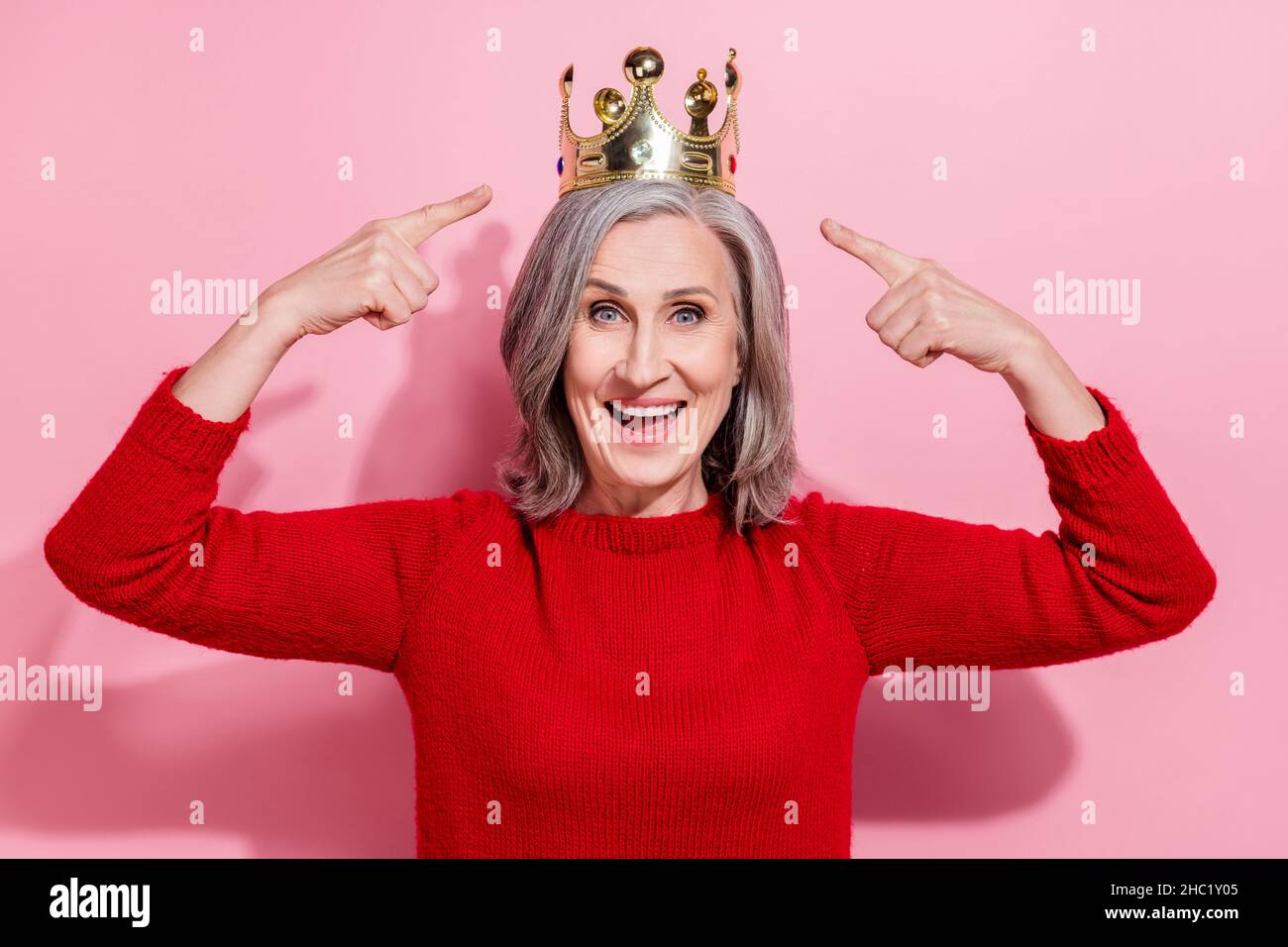 Portrait of attractive cheerful grayhaired woman celebrating
