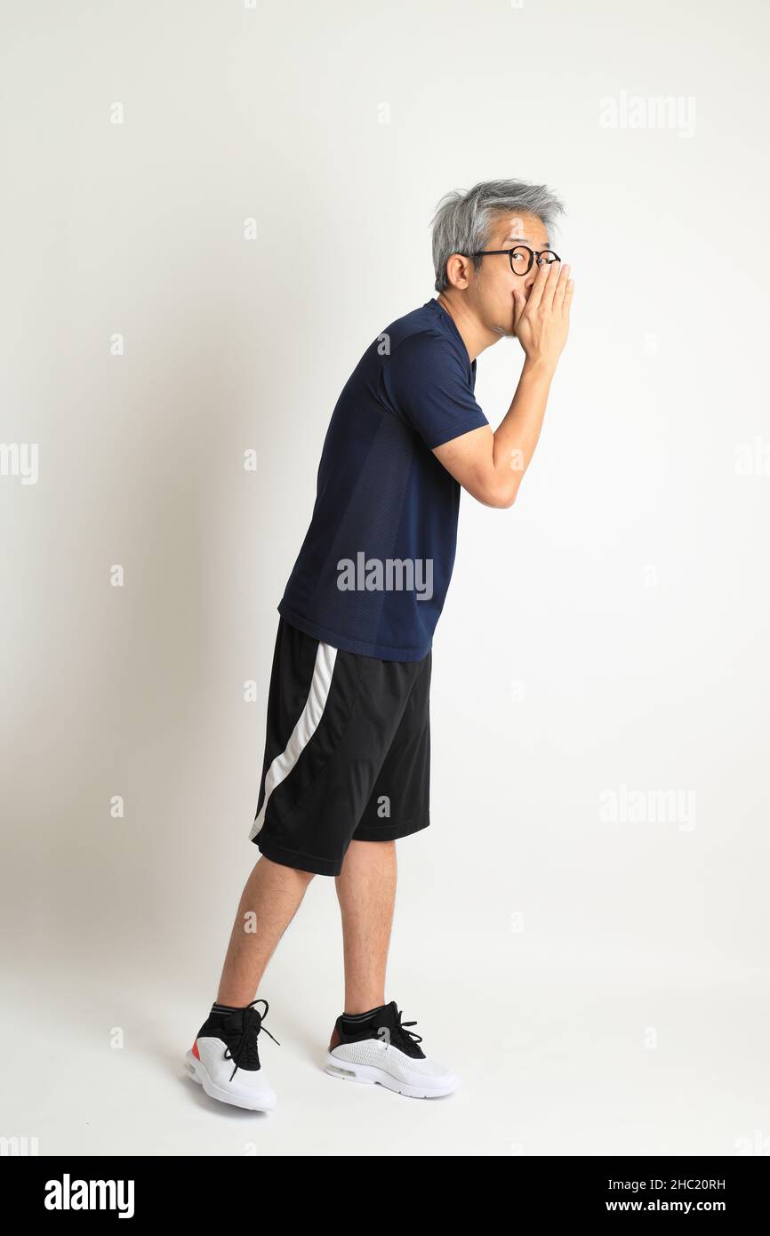 The Asian senior man with sport clothes on the white background Stock ...