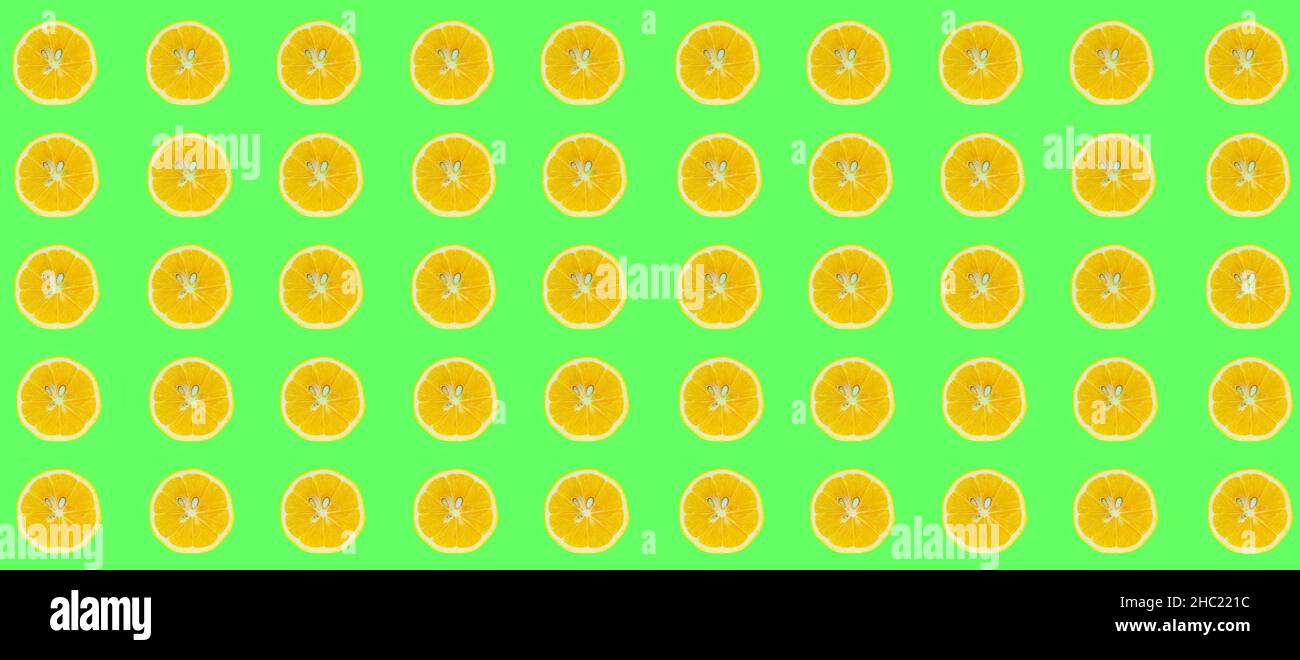 Lemon slices, top view of lemon slices isolated on a green background. Citrus pattern concept photo. Stock Photo