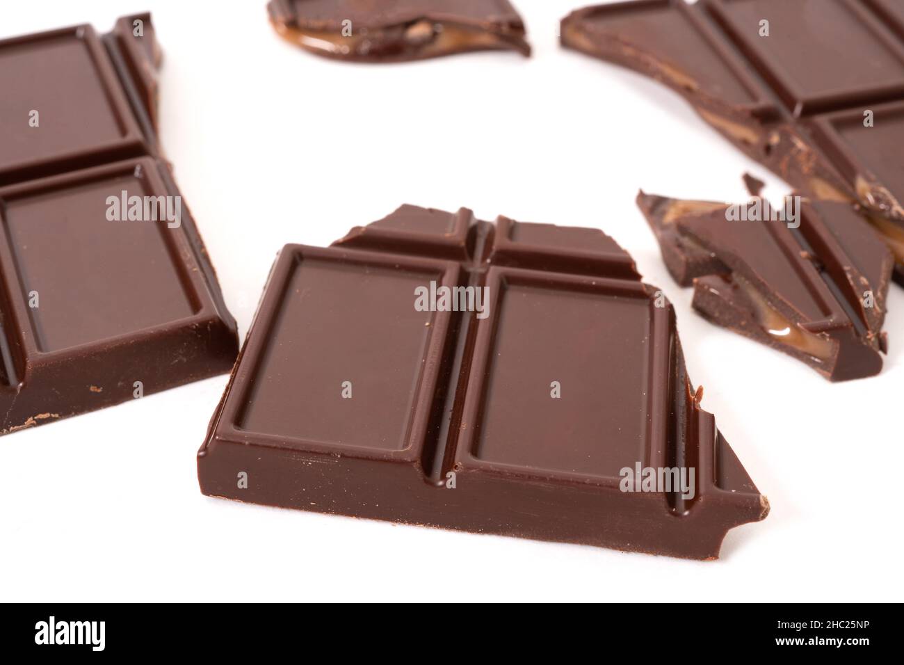 Dark chocolate bar and cubes with cream filling inside. Selective focus Stock Photo