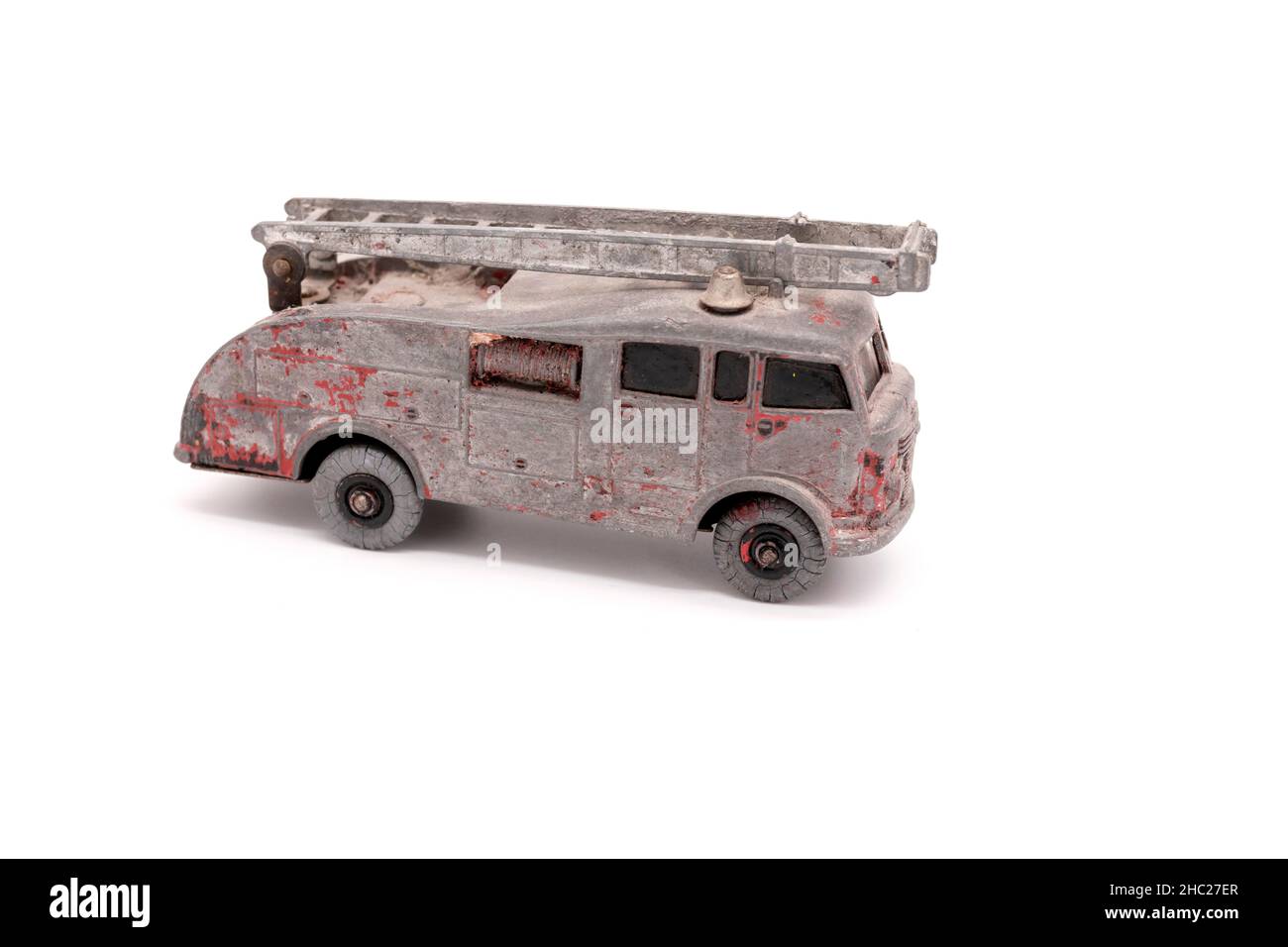 old dinky toys original 55 fire engine toy isolated on white studio background with distressed paintwork Stock Photo