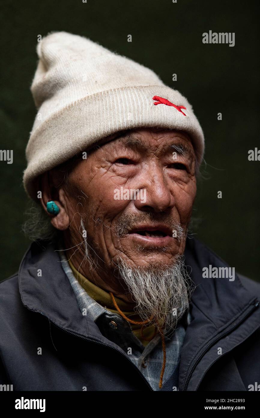 (211219) -- LHASA, Dec. 19, 2021 (Xinhua) -- Tsering Dondrup poses for a portrait in southwest China's Tibet Autonomous Region, May 13, 2021. Born in 1947, Tsering Dondrup lives in Jianggang Village, Nyalam County of Tibet.    Tsering and his family members served as enslaved farmers for their serf owner in old Tibet. Drudgeries including farming, collecting firewood and cow dung fell on them with little rations could be earned from serf owner. When it came to harvest, the ripe highland barley they had planted were claimed by serf owner. 'If we show any sluggishness during work, the serf owner Stock Photo