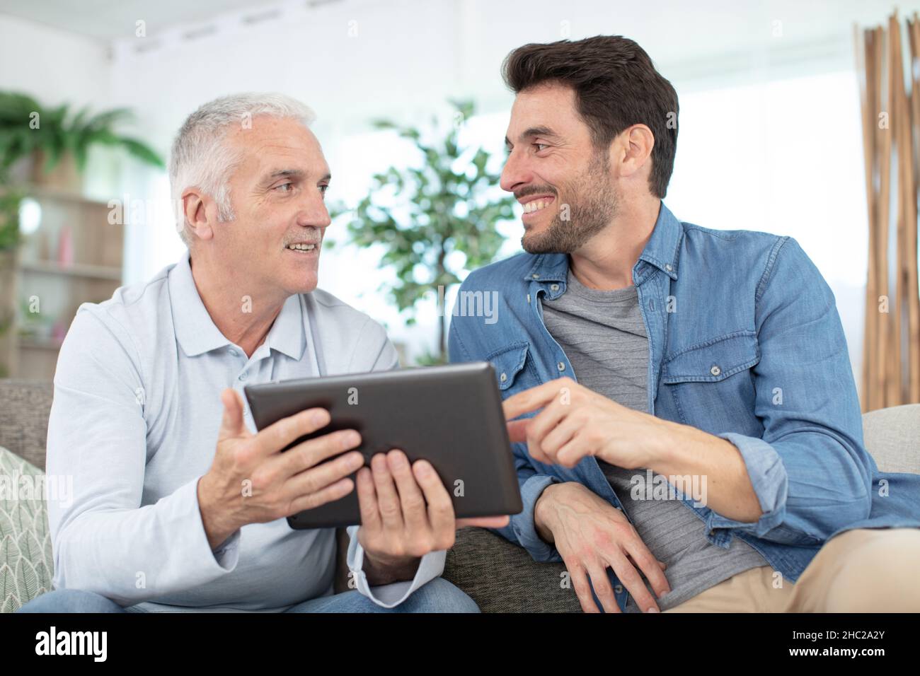 senior father and young son with tablet Stock Photo