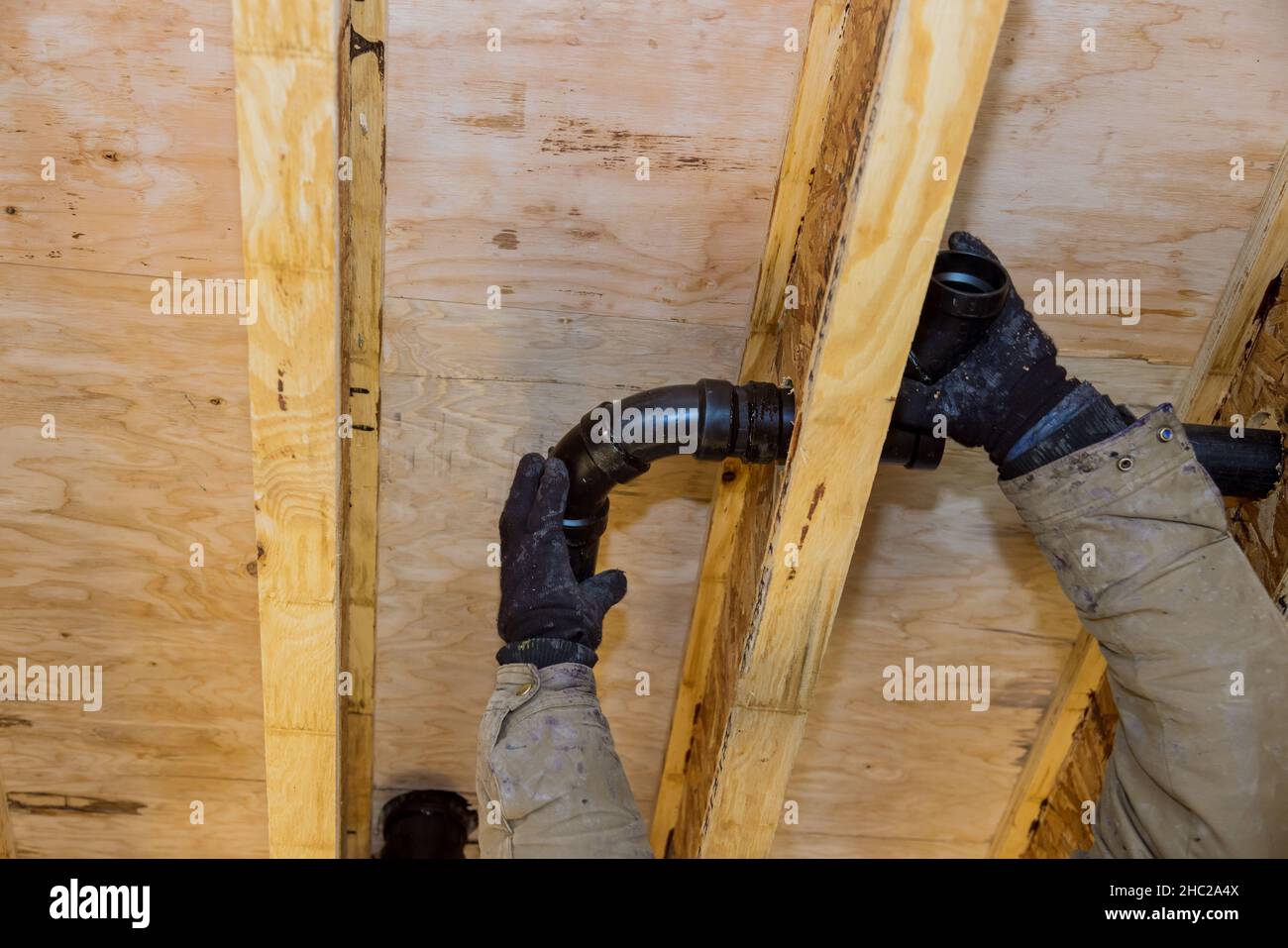 Gluing parts of a PVC sewage drain using cement glue assembly