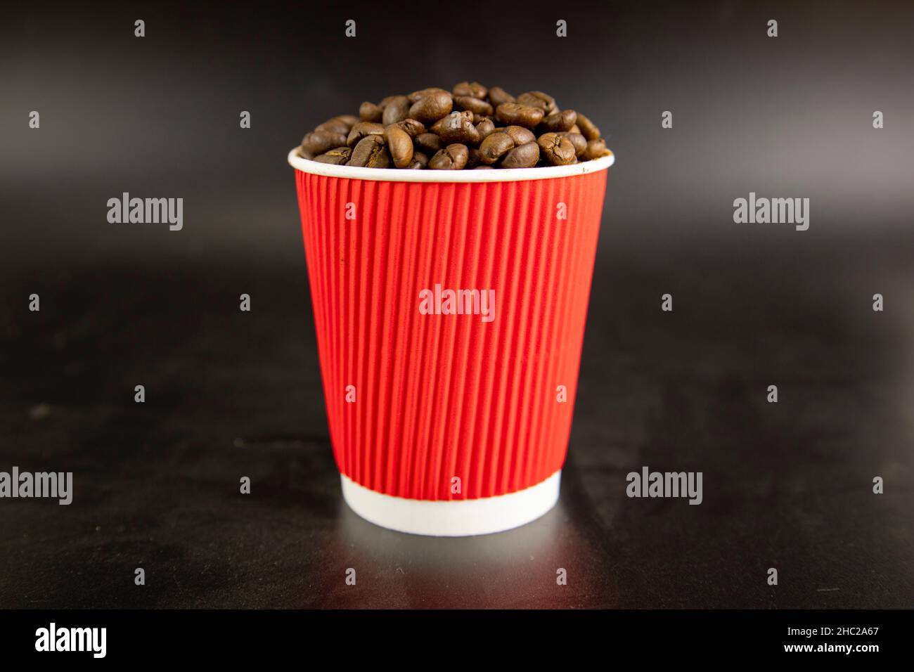 Coffee beans in a red paper cup Stock Photo