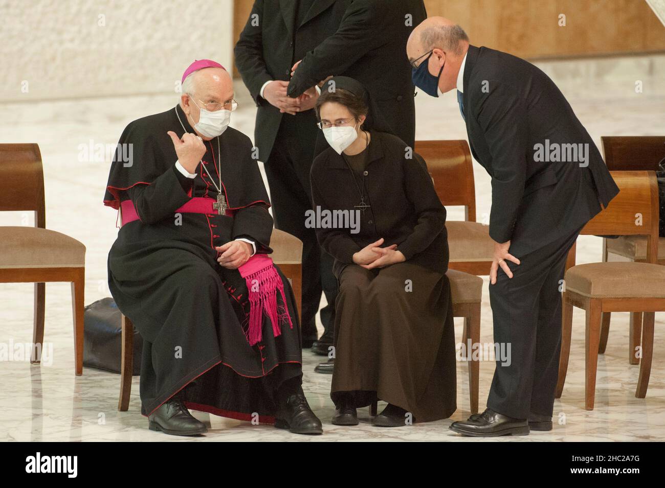 Rome, Italy. 23rd Dec, 2021. Italy, Rome, Vatican, 21/12/23. from left: Msgr. Fernando Vergez Alzaga, Sister Raffaella Petrini and Giuseppe Puglisi, speaks during the audience with Vatican's employees in the Paul VI Hall.Photo by Massimiliano MIGLIORATO/Catholic Press Photo Credit: Independent Photo Agency/Alamy Live News Stock Photo