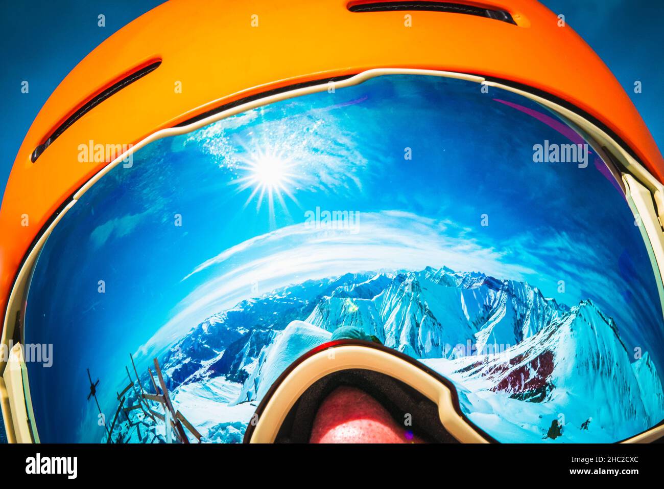 Close up skiers person goggles with mountains panorama reflection. Ski holiday in caucasus mountains Stock Photo